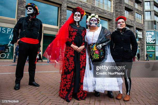 People dressed up as Catrina or Catrin, the female and male skeletons to celebrate in advanced the celebration of Day of Dead or Dias de los Muertos,...