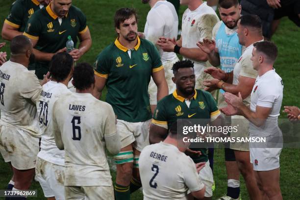 South Africa's lock Eben Etzebeth and South Africa's blindside flanker and captain Siya Kolisi walk through a guard of honour at the end of the...