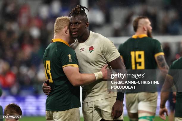 South Africa's prop Vincent Koch and England's lock Maro Itoje embrace at the end of the France 2023 Rugby World Cup semi-final match between England...