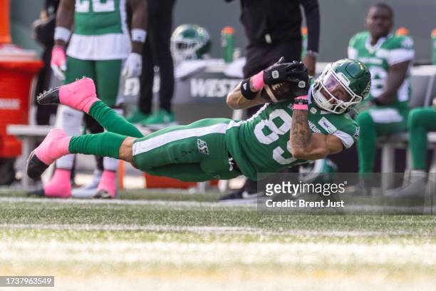 Kian Schaffer-Baker of the Saskatchewan Roughriders makes a diving catch on the first play from scrimmage in the game between the Toronto Argonauts...