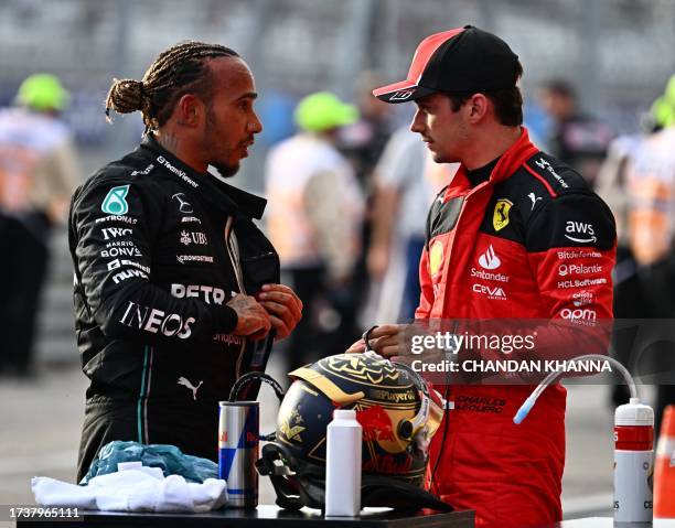 Mercedes' British driver Lewis Hamilton speaks with Ferrari's Monegasque driver Charles Leclerc after the Sprint race at the Circuit of the Americas...