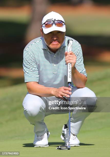 Charlie Wi surveys the slope of the 17th green during the second round of the Dominion Energy Charity Classic on October 21 at The Country Club of...