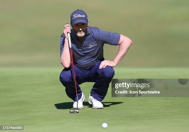 Mark Hensby surveys the slope of the 17th green during the second round of the Dominion Energy Charity Classic on October 21 at The Country Club of...