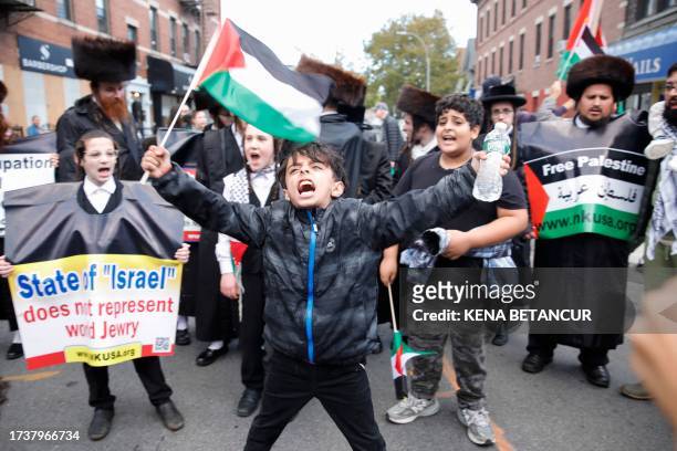 Boy shout slogans as a group from NKUSA stands in support of Palestinians in Brooklyn, New York on October 21 amid ongoing conflict between Israel...