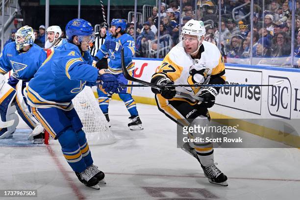 Jeff Carter of the Pittsburgh Penguins passes the puck as Torey Krug of the St. Louis Blues defends on October 21, 2023 at the Enterprise Center in...