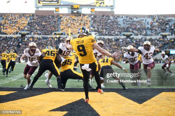 Punter Tory Taylor of the Iowa Hawkeyes punt the ball away from his own end zone during the second half against the Minnesota Golden Gophers at...