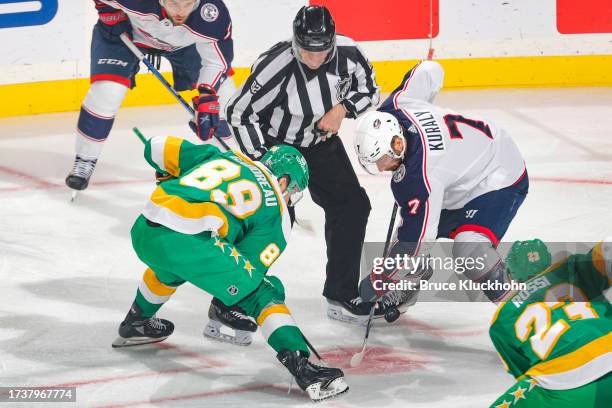 Frederick Gaudreau of the Minnesota Wild takes a face-off against Sean Kuraly of the Columbus Blue Jackets during the game at the Xcel Energy Center...