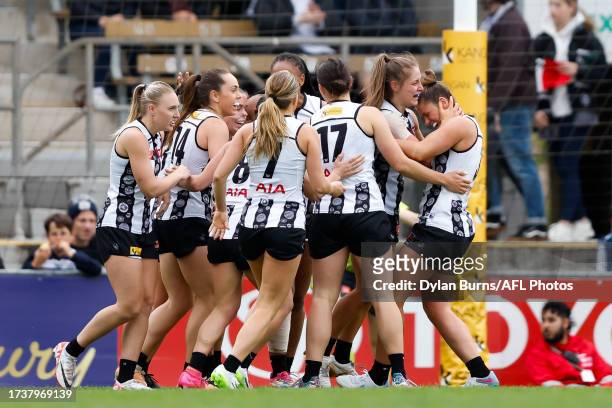The Magpies celebrate a goal during the 2023 AFLW Round 08 match between The Collingwood Magpies and The Geelong Cats at Victoria Park on October 22,...