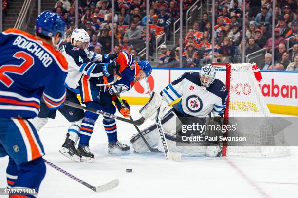 Connor Hellebuyck of the Winnipeg Jets stops a shot during the third period against the Edmonton Oilers at Rogers Place on October 21, 2023 in...