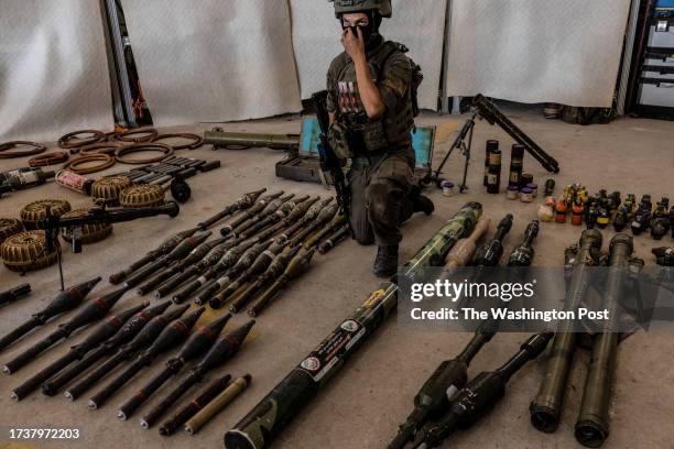 Major G ,right, as he shows the cache of Hamas weapons at a military base in southern Israel as he explains the different types of Hamas weapons the...