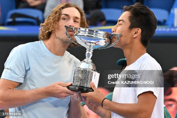 Australian doubles pair Rinky Hijikata and Max Purcell kiss the champion trophy during the awards ceremony of the men's doubles final against Jamie...