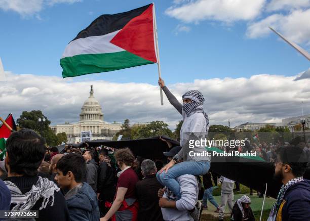 Demonstrator holding a Palestinian flag while joining a demonstration near the Capitol building in Washington DC. Thousands of pro-Palestinian...