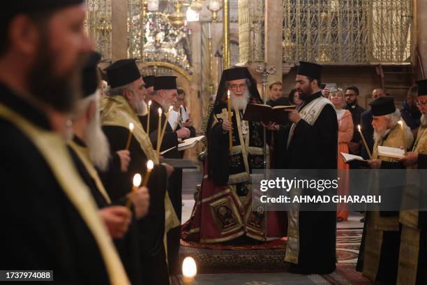 Greek Orthodox Patriarch of Jerusalem Theophilos III leads prayers during a procession dedicated to peace in Israel and Gaza, at the Holy Sepulchre...