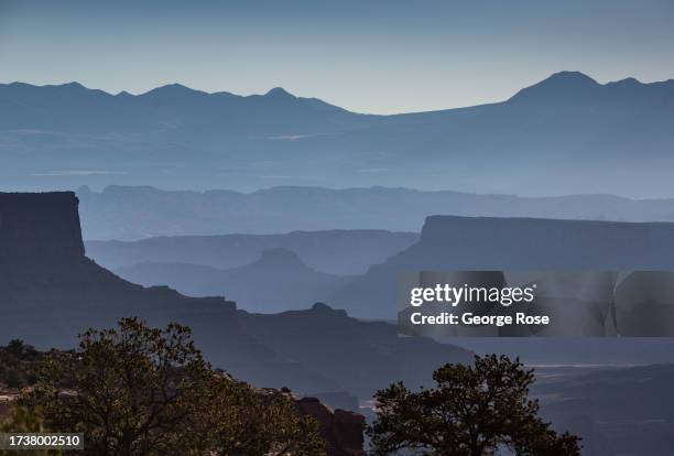 Hazy sky looking toward the La Sal Mountains is viewed near the Island in the Sky Park entrance on October 5, 2023 near Moab, Utah. Canyonlands...