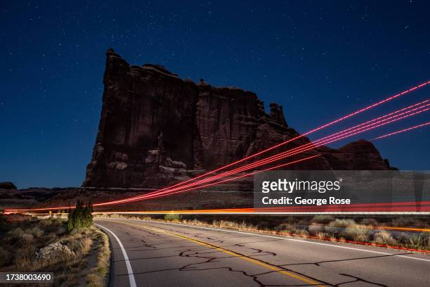 The road through the Courthouse Towers is viewed two hours before sunrise and under moonlight in this time exposure taken on October 5, 2023 near...