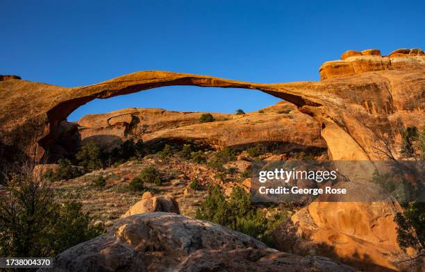 Landscape Arch is viewed at sunrise on October 5, 2023 near Moab, Utah. Arches National Park, one of the Fabulous Five Utah Parks, is located in...