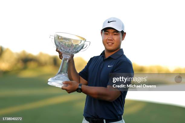 Tom Kim of South Korea poses with the trophy after putting in to win on the 18th green during the final round of the Shriners Children's Open at TPC...