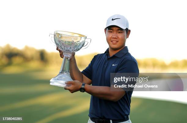 Tom Kim of South Korea poses with the trophy after putting in to win on the 18th green during the final round of the Shriners Children's Open at TPC...