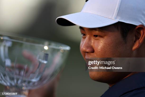 Tom Kim of South Korea poses with the trophy after putting in to win on the 18th green during the final round of the Shriners Children's Open at TPC...