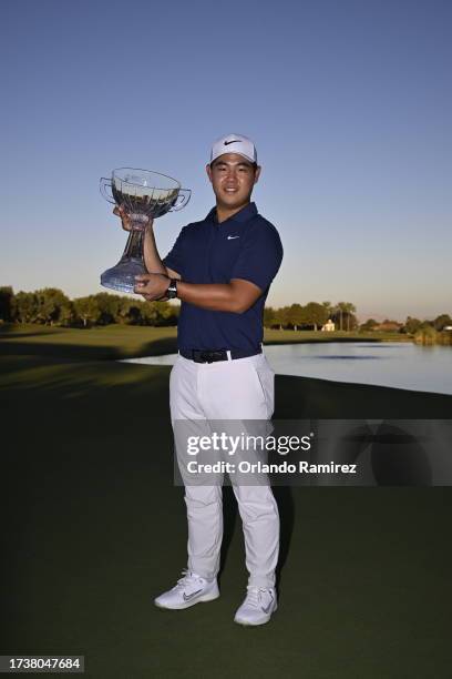 Tom Kim of South Korea poses with the trophy after putting in to win on the 18th green during the final round of the Shriners Children's Open at TPC...