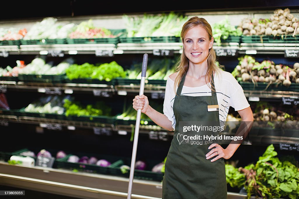Grocer smiling in produce section