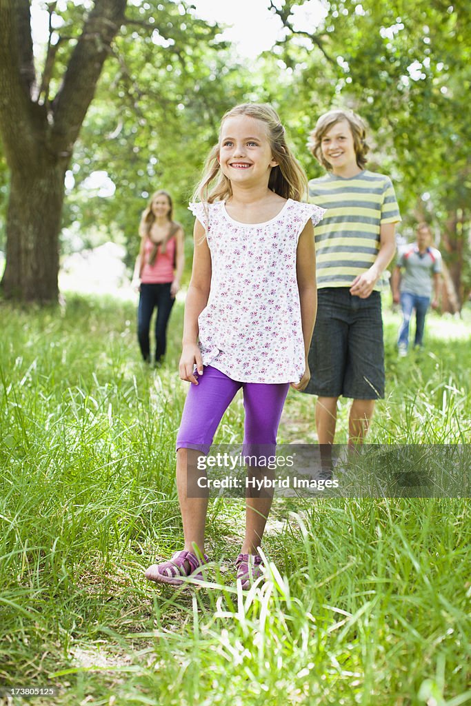 Children walking together in grass