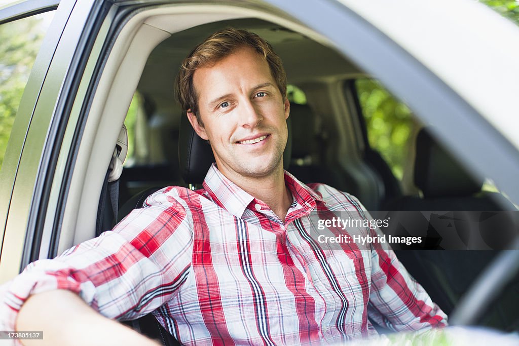 Smiling man sitting in car