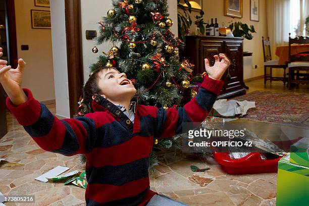 boy cheering by christmas tree - open day 9 bildbanksfoton och bilder