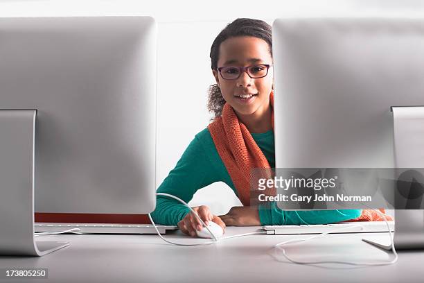 woman using computer at desk - girl desk stock pictures, royalty-free photos & images