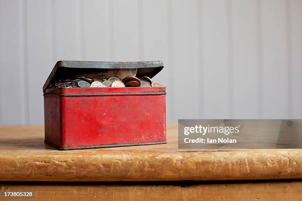 antique tin full of money on desk - hiding money stock pictures, royalty-free photos & images