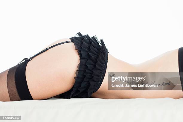 woman wearing lingerie on bed - pin up girl tattoo stock pictures, royalty-free photos & images