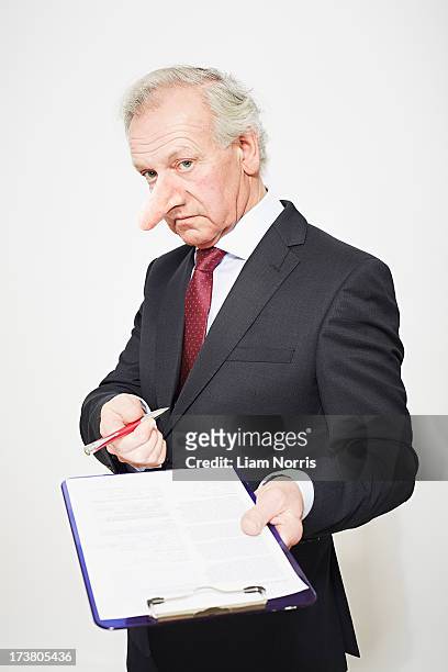businessman with long nose and contract - long nose stock pictures, royalty-free photos & images