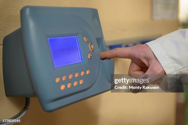 worker clocking in using fingerprint recognition technology in food factory - time clock stock pictures, royalty-free photos & images