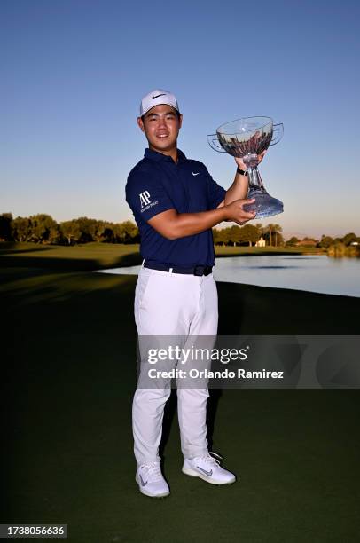 Tom Kim of South Korea poses with the trophy after putting in to win on the 18th green during the final round of the Shriners Children's Open at TPC...