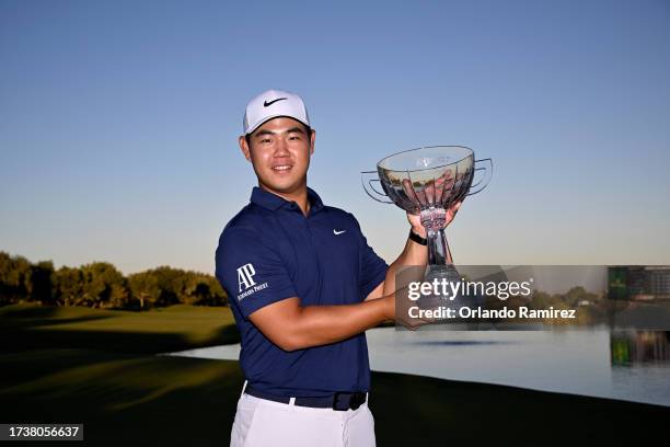 Tom Kim of South Korea poses with the trophy after putting in to win on the 18th green during the final round of the Shriners Children's Open at TPC...