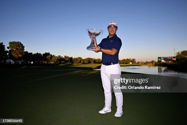 Tom Kim of South Korea poses with the trophy after putting in to win on the 18th green during the final round of the Shriners Children's Open at TPC...