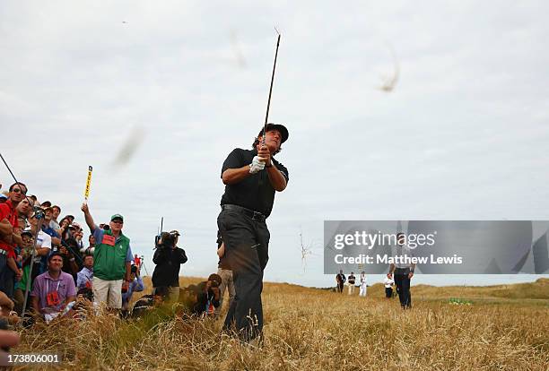 Phil Mickelson of the United States hits from the rough on the 5th during the first round of the 142nd Open Championship at Muirfield on July 18,...