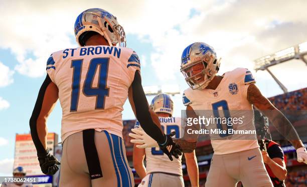 Marvin Jones Jr. #0 and Amon-Ra St. Brown of the Detroit Lions celebrate a touchdown during a game against the Tampa Bay Buccaneers at Raymond James...