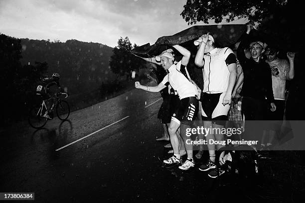 Cycling fans encourage the riders in the poor weather conditions during stage seventeen of the 2013 Tour de France, a 32KM Individual Time Trial from...