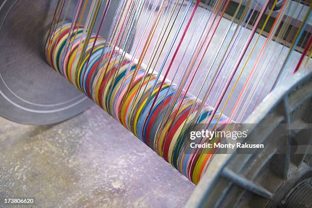 multicoloured silk yarn on industrial loom in textile mill - loom stock pictures, royalty-free photos & images