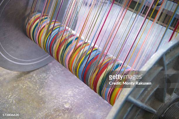multicoloured silk yarn on industrial loom in textile mill - loom 個照片及圖片檔