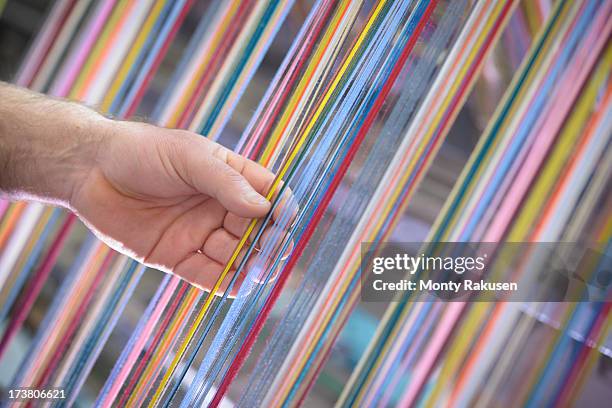 worker adjusting multicoloured silk yarn on industrial loom in textile mill - yarn loom stock pictures, royalty-free photos & images