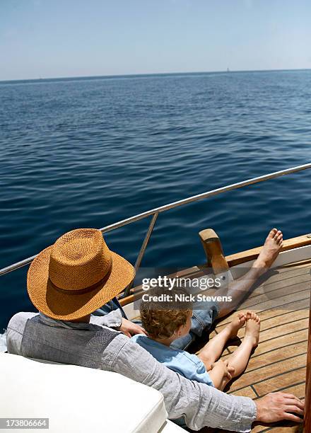 father and son relaxing on boat - father son sailing stock pictures, royalty-free photos & images
