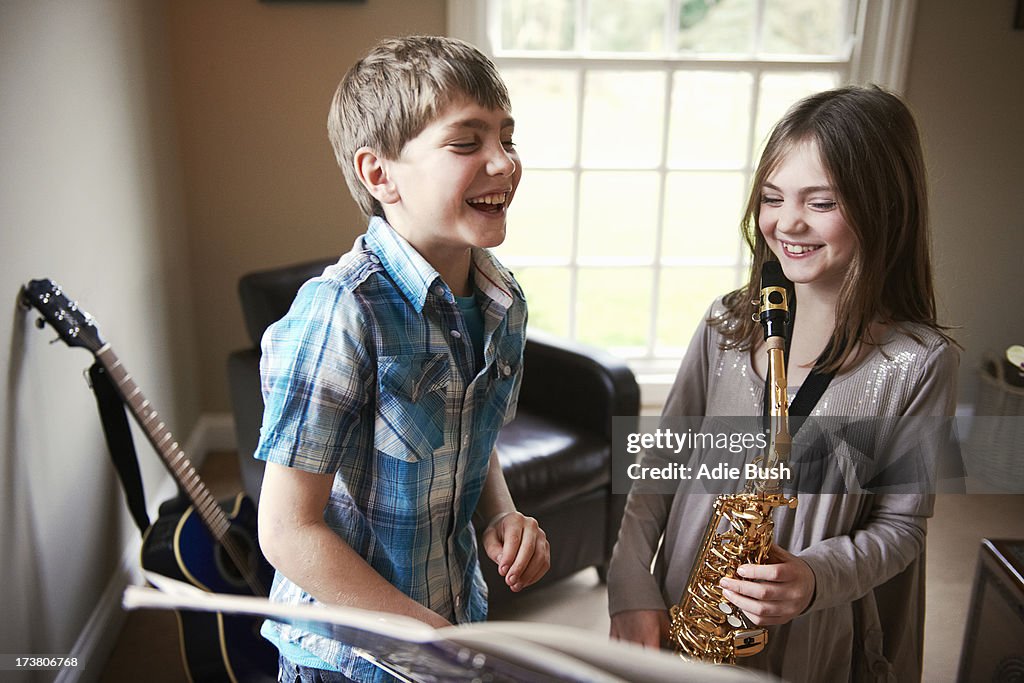 Children playing with saxophone