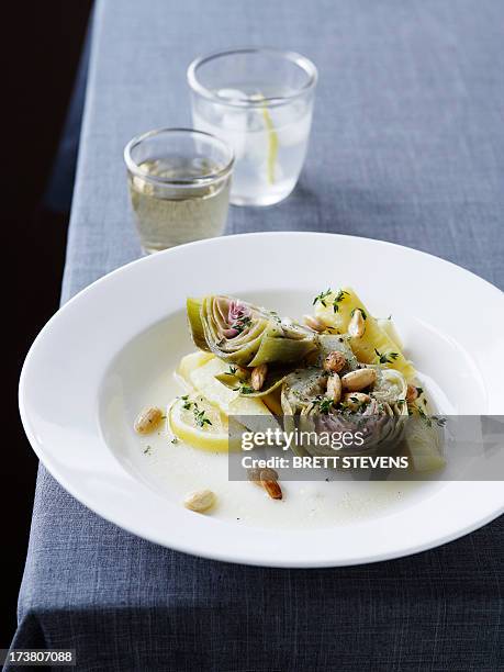 plate of artichoke and lemon salad - artichoke stock pictures, royalty-free photos & images