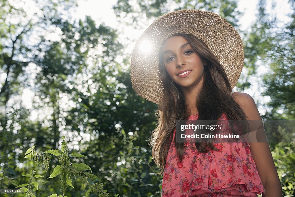 Teenage girl wearing straw hat outdoors