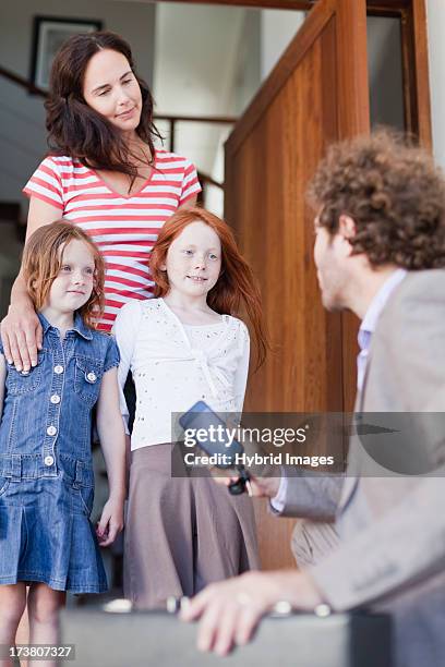 businessman saying goodbye to family - answering door stock pictures, royalty-free photos & images