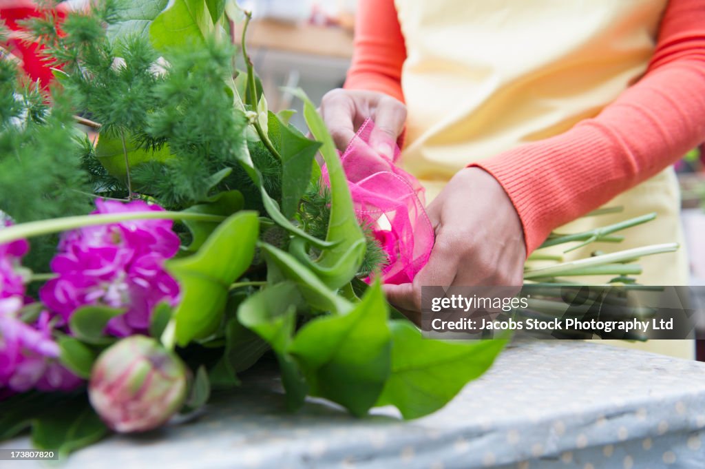 Mixed race woman working in florist shop