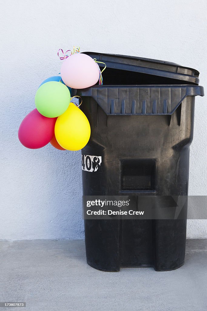 Bunch of balloons in garbage can