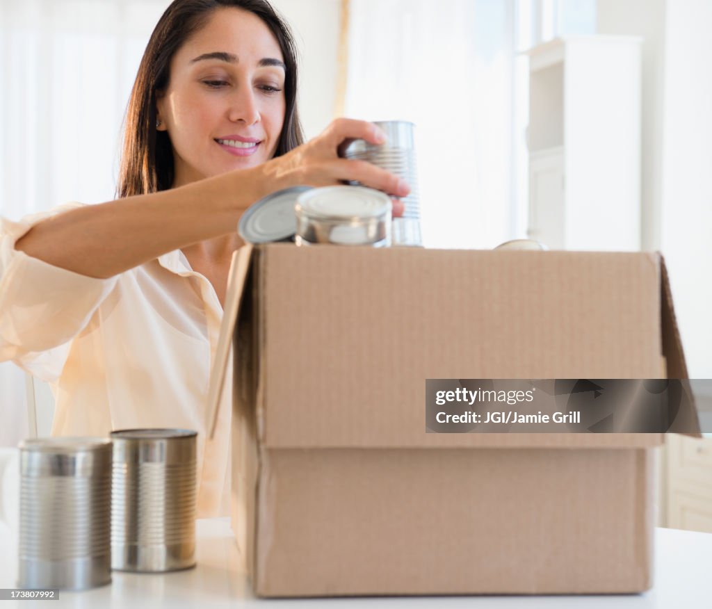 Caucasian woman recycling cans